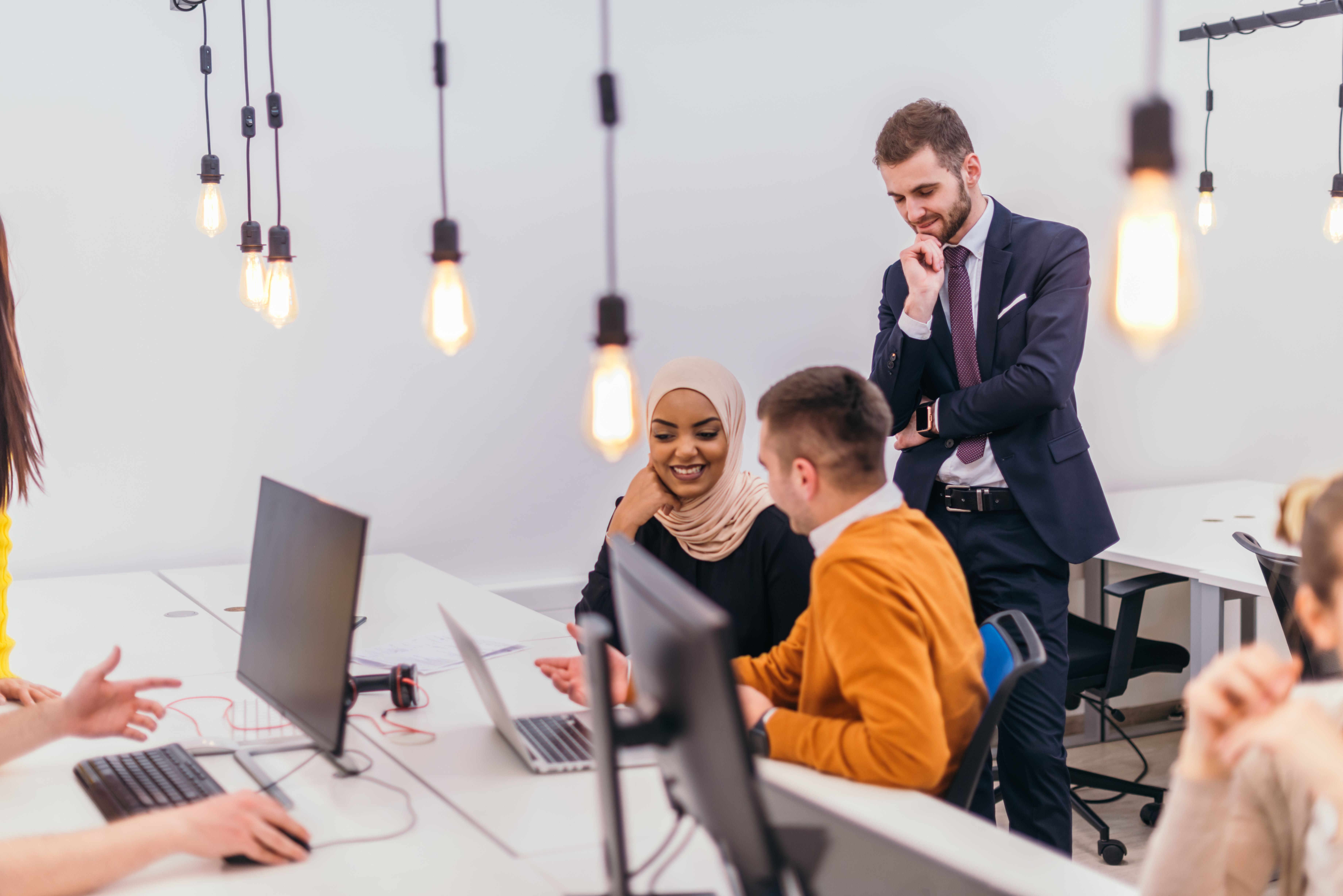 Group of multi-ethnic colleagues working on desktop computers an